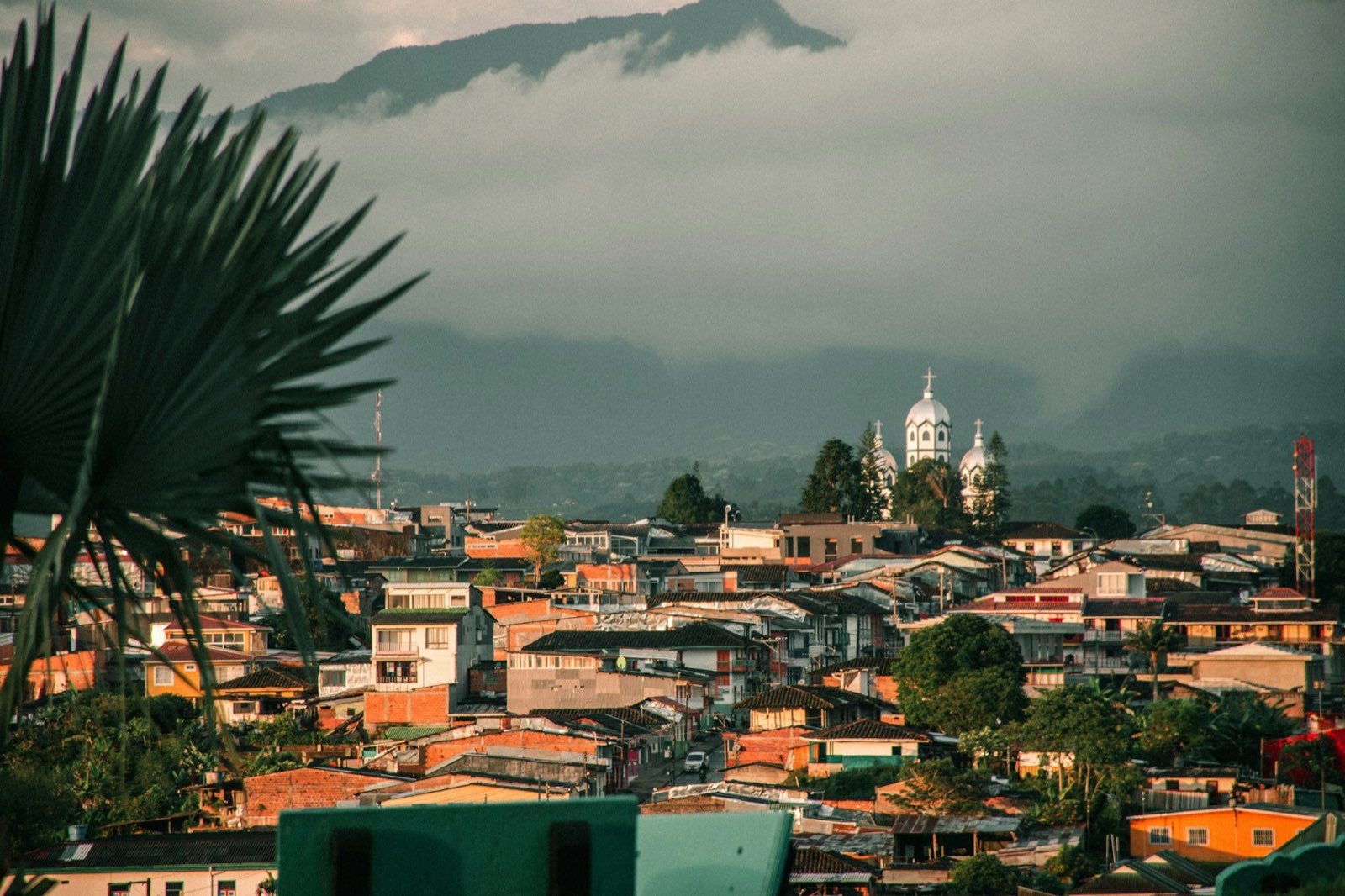 A Costa Rican town nestled in the mountains with colorful buildings and lush surroundings